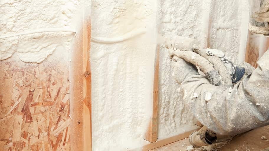 Workers installing spray foam insulation